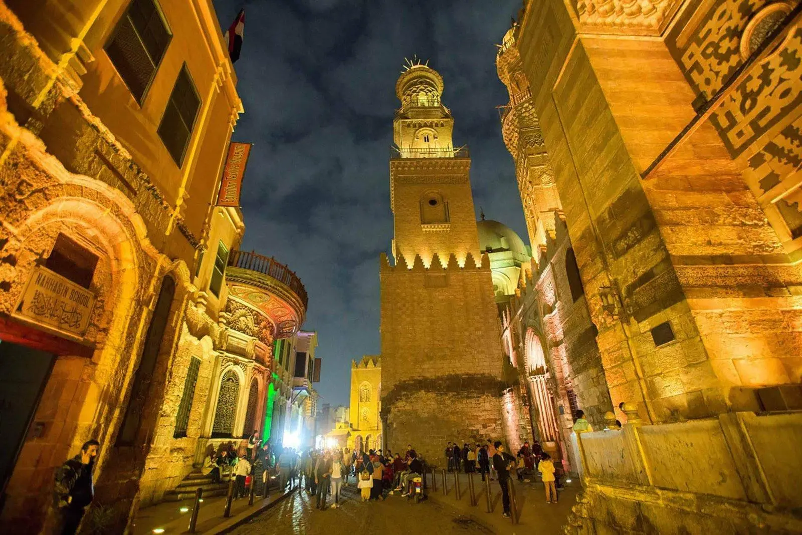 Historic Al-Muizz Street in Islamic Cairo, featuring medieval architecture and ancient monuments.