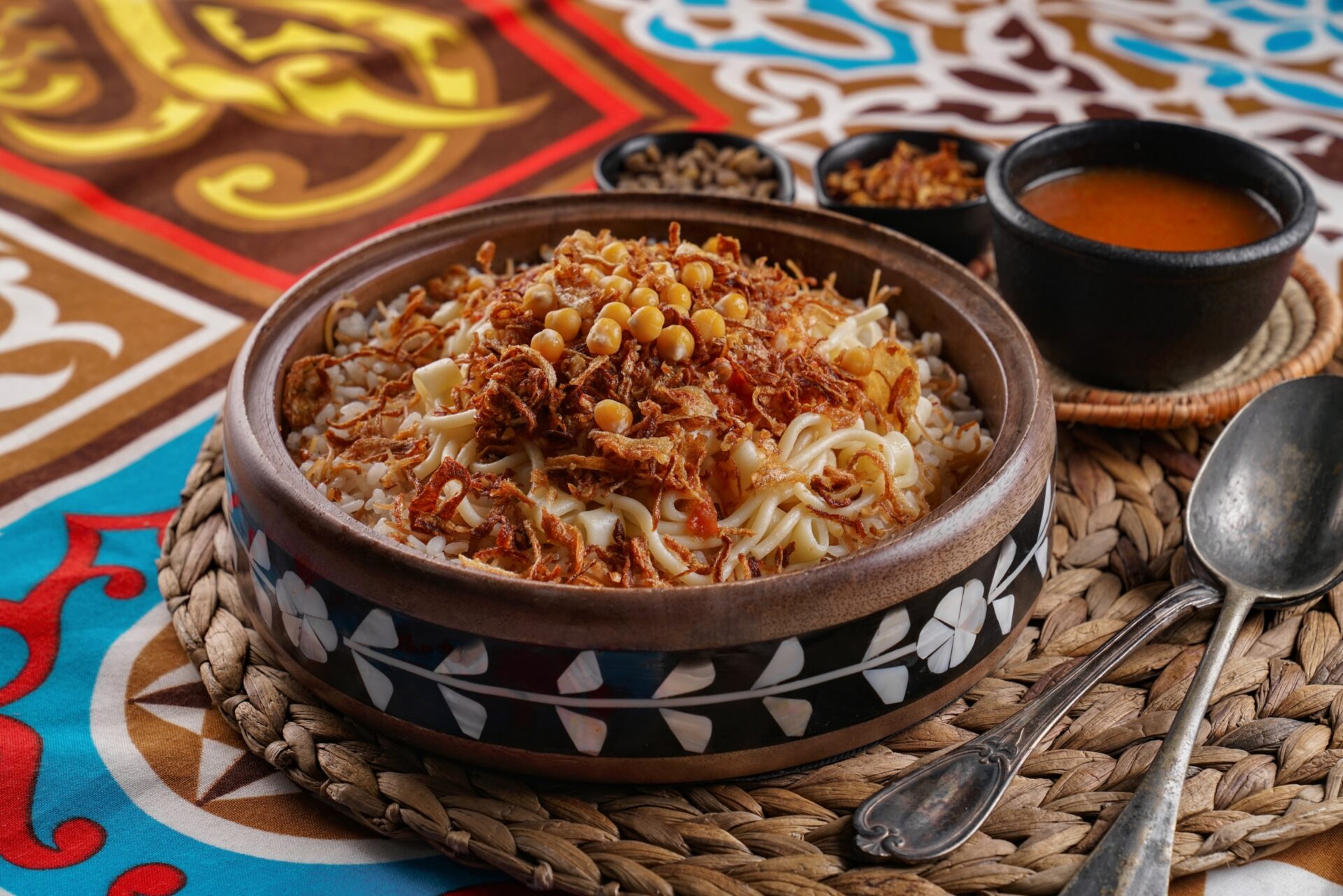 Traditional Egyptian koshari with rice, lentils, pasta, chickpeas, tomato sauce, and crispy fried onions
